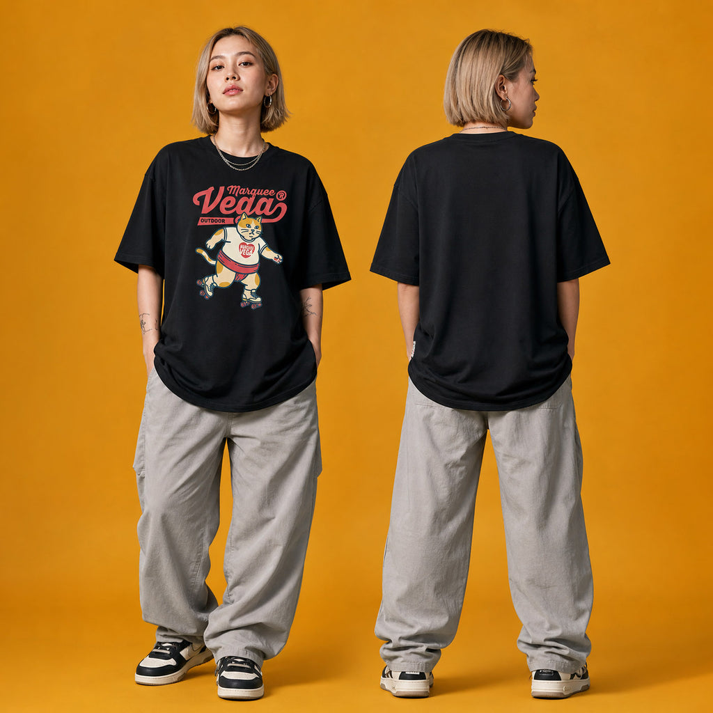 Model wearing the Vega Outdoor Roller Cat heavyweight loose fit graphic tee in Vintage Black, shown in styled product photography.