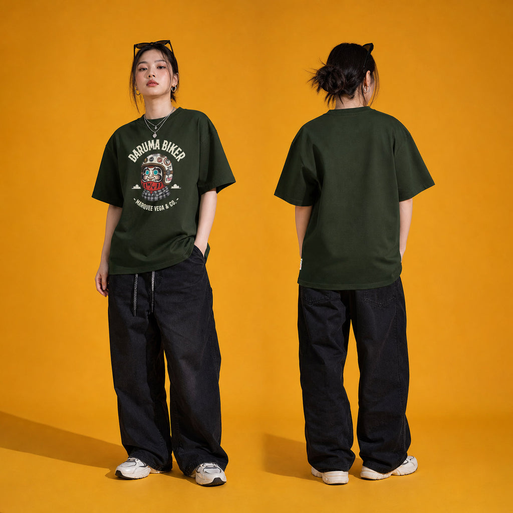 Female model wearing the Daruma Biker heavyweight loose fit graphic tee in Racing Green, shown front and back.