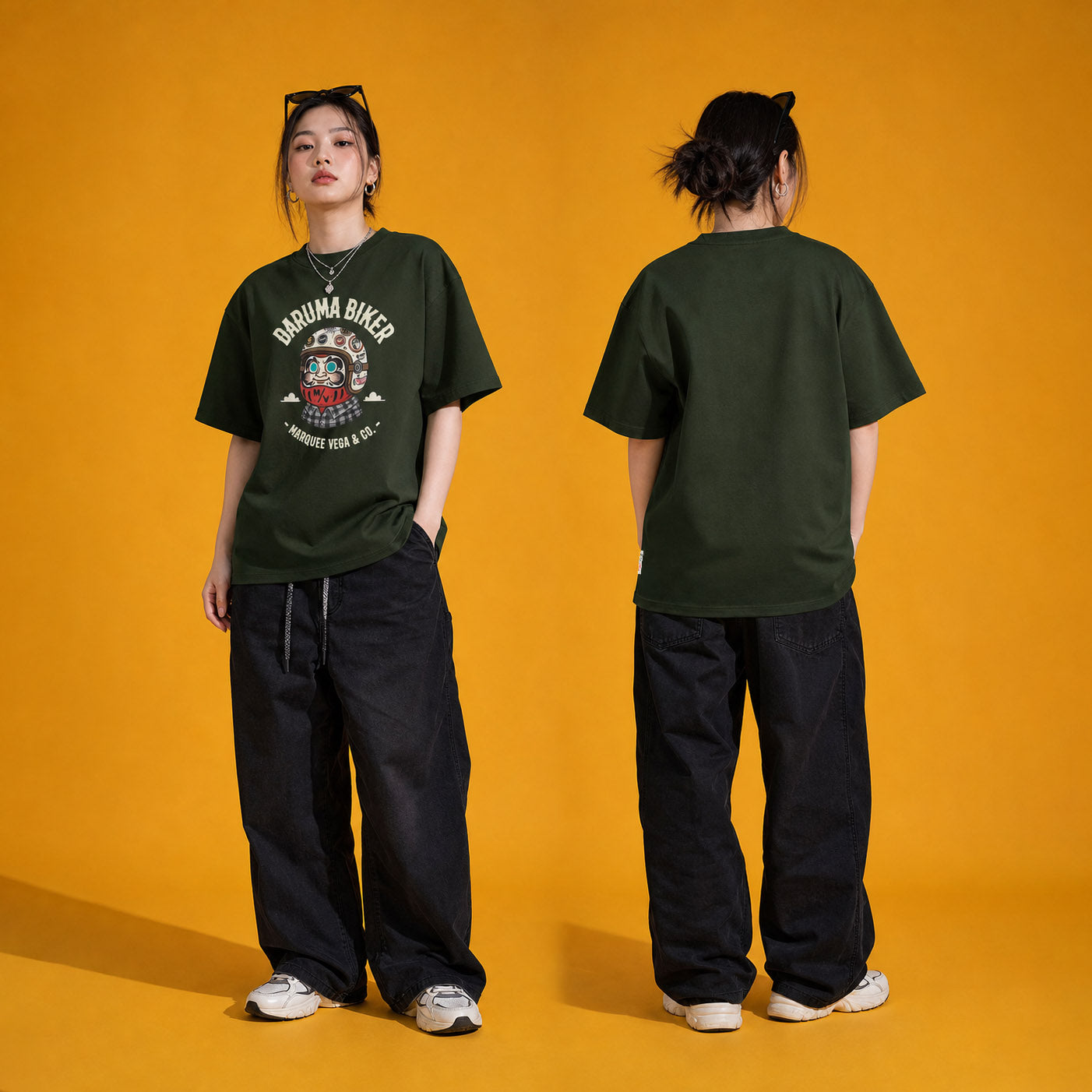 Female model wearing the Daruma Biker heavyweight loose fit graphic tee in Racing Green, shown front and back.