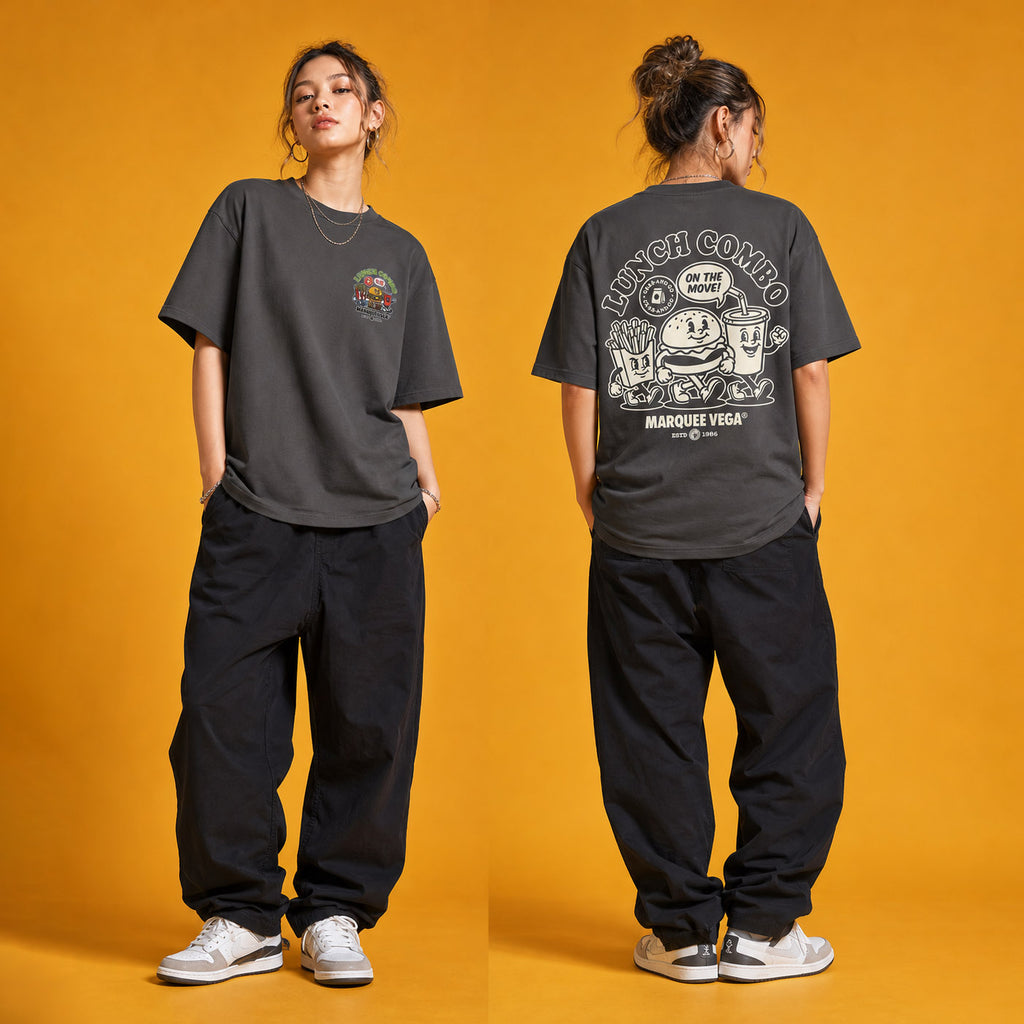 Female model wearing the Lunch Combo On The Move heavyweight loose fit graphic tee in Charcoal Grey, shown front and back.