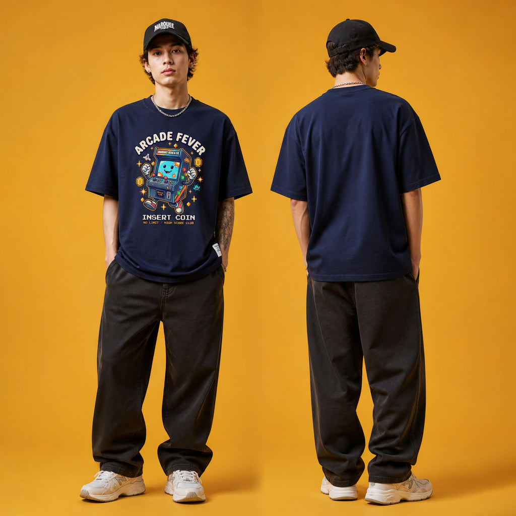 Male model wearing the Arcade Fever Insert Coin heavyweight loose fit graphic tee in Navy Blue, shown front and back.