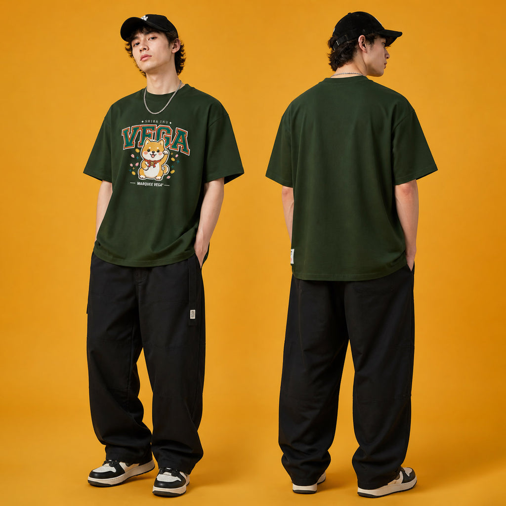 Male model wearing the Shiba Inu Vega heavyweight loose fit graphic tee in Racing Green, shown front and back.