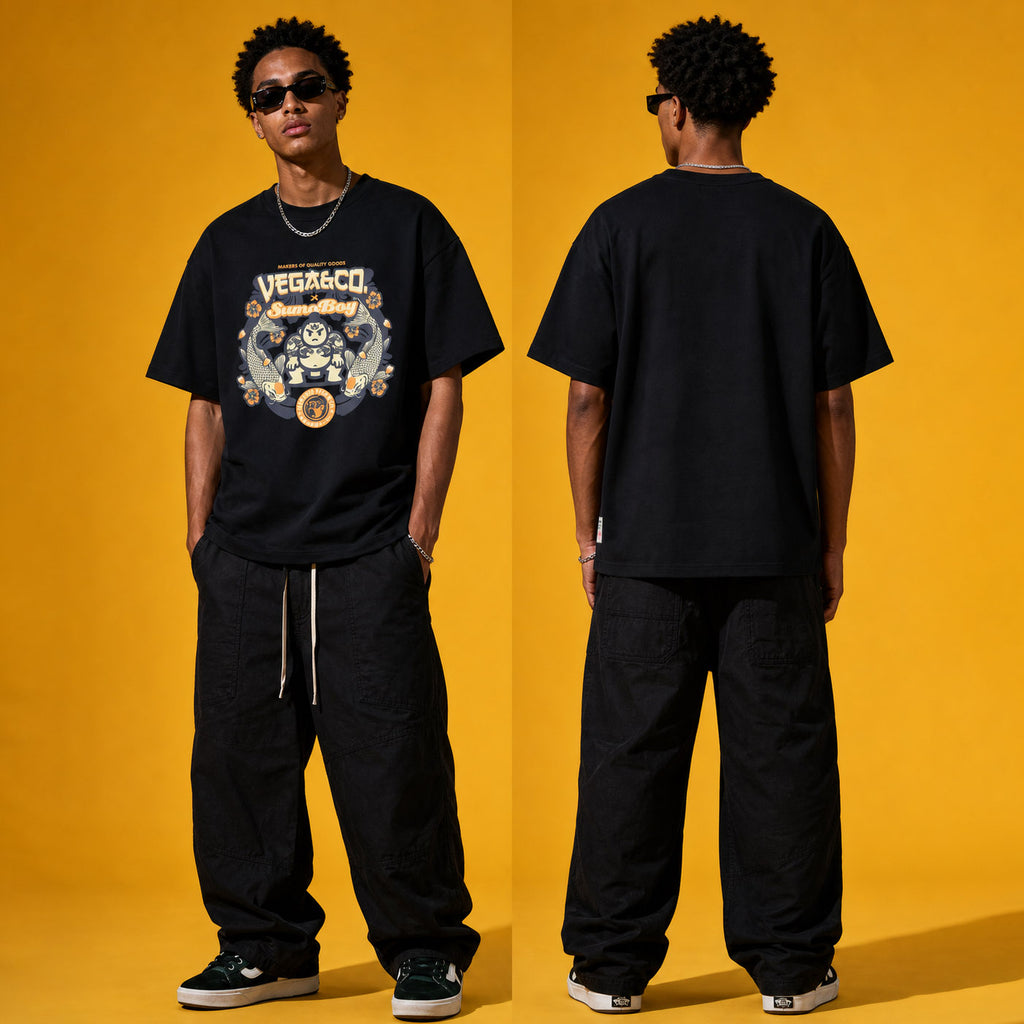 Model wearing the Vega & Co. Sumo Boy heavyweight loose fit graphic tee in Vintage Black, shown front and back.